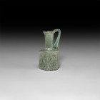 Byzantine Iridescent Mould Blown Jug
6th-8th century AD. An iridescent mould-blown glass jug with hexagonal-section body, trumpet-shaped neck and mou...