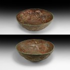 Western Asiatic Repoussé Bowl with Hunting Scene
1st millennium BC. A sheet bronze bowl with central disc and beaded band, frieze depicting two arche...