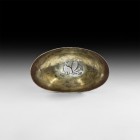 Western Asiatic Sassanian Silver Bowl with Peacock
6th century AD. A bronze oval bowl with rounded body and base; gilt inner face with reserved repou...