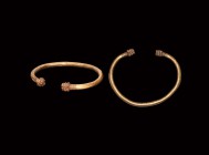 Western Asiatic Gold Bracelet with Lion Head Terminals
1st millennium AD. A gold round-section penannular bracelet with finials formed as stylised li...