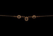 Western Asiatic Jewish Gold Necklace
18th-19th century AD. A gold necklace with hook-and-eye fastener, four spherical garnet beads with gold filigree...