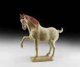 Chinese Tang Prancing Horse
Tang Dynasty, 618-906 AD. A ceramic horse figurine with one foreleg raised, elegantly arched neck with long flowing mane ...