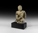 Gandharan Winged Atlas Figure
2nd-4th century AD. A substantial carved and schist figure of Atlas crouching with wings folded to the rear, the head r...