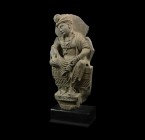Gandharan Seated Bodhisattva Statue
1st-4th century AD. A carved schist frieze fragment of a bodhisattva (Avalokite?vara?) seated on a ledge; the bas...