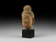 Gandharan Buddha Head
2nd-4th century AD. A ceramic head of Buddha with hair piled in an elaborate topknot, eyes half-closed in contemplation, socket...