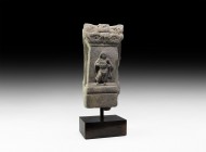 Gandharan Figural Frieze Section with Musician
2nd-4th century AD. A carved schist frieze fragment comprising a tapering rectangular column with foli...