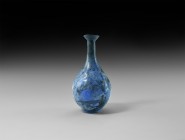 Islamic Blue Glass Vase
12th-14th century AD. A glass piriform vase with basal ring and trumpet mouth, mottled blue glass with black swirls, some iri...
