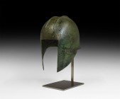 Greek Illyrian Helmet
Archaic Period, 6th century BC. A bronze helmet raised from a single sheet, the bowl of domed form with two parallel corrugated...