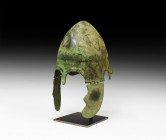 Greek Chalcidian Helmet
Early 4th century BC. A Chalcidian helmet formed as a bronze bowl with carination to the crown, flared edges at the ear openi...