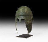 Greek Chalcidian Helmet
Early 4th century BC. A bronze helmet of Chalcidian type formed as a bowl with carination to the crown and everted bands at t...