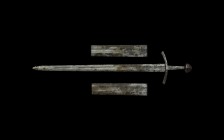 Medieval Double-Edged 'ORVSEMDNVS' Sword
12th century AD. A two-edged iron sword of piled construction with broad tapering blade and shallow fuller t...