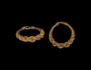 Viking Gold Plaited Wire Ring
9th-11th century AD. A gold ring with hoop of four expanding rods plaited, looped to the reverse and the ends wound abo...