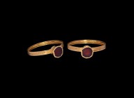 Merovingian Gold Ring with Garnet
6th-7th century AD. A gold finger ring comprising a flat-section hoop with beaded median band, trumpet-shaped bezel...