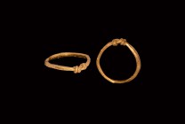 Viking Gold Ring
11th-12th century AD. A gold ring comprising a length of lozenge-section rod closed with tapering ends coiled around the shank. Disc...