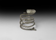 Viking Silver Twisted Arm-Ring
10th-12th century AD. A silver coiled arm-ring, round in section with alternating twisted and plain segments, Y-shaped...