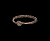 Viking Silver Plaited Bracelet
9th-11th century AD. A plaited silver bracelet formed of three round-section rods with thinner twisted wire wound abou...