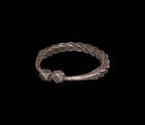 Viking Silver Plaited bracelet
9th-11th century AD. A large silver penannular bracelet formed from rectangular rods twisted about each other, decorat...