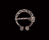 Viking Silver Plaited Penannular Brooch
9th-11th century AD. A silver penannular brooch formed from three rods twisted about each other, three applie...
