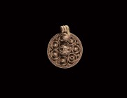 Viking Silver Filigree Pendant
9th-11th century AD. A circular silver pendant with applied filigree frame, the upper face decorated with a band of fi...