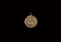 Viking Gilt Silver Beast Pendant
10th-12th century AD. A silver-gilt disc pendant with integral loop, high-relief beaded border and coiled beast moti...