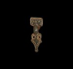 Anglo-Saxon Chip-Carved Brooch
6th-7th century AD. A beautiful small gilt bronze square-headed brooch of classic form, the headplate having a billete...