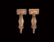 Merovingian Gilt Silver Brooch Pair
6th century AD. A matched pair of silver-gilt bow brooches, each with rectangular headplate and geometric detaili...