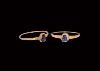 Medieval Gold Stirrup Ring with Sapphire
13th-14th century AD. A gold stirrup ring comprising a round-section slender hoop, pie-dish bezel with inset...