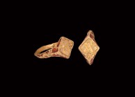 Medieval Gold Ring with Initial 'A'
13th-14th century AD. A gold ring comprising a cusped D-section hoop, flared shoulders and lozengiform plaque, ba...