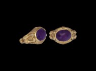 Medieval Gold Ring with Amethyst and Four Peacocks
14th-15th century AD. A Burmese hollow-formed gold ring with D-section bezel, to each shoulder a p...
