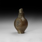 Post Medieval Bellarmine Jar
16th century AD. A salt-glazed stoneware jug of bartmannskrug type with bulbous body, narrow base, ribbed collar and str...