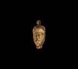 Georgian Gold Janiform Head Pendant
17th-18th century AD. A gold hollow-form pendant depicting a janiform saint with stern expression, long curly bea...