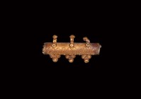 Early Christian Amulet Case
3rd-4th century AD. A gold amulet case comprising a tubular sleeve, with three suspension loops, applied wire decoration ...