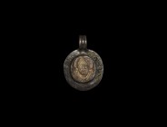 Post Medieval Silver Pendant with Bone St Nicholas Inlay
17th century AD. A silver disc pendant with integral ribbed loop, central cell to one face w...
