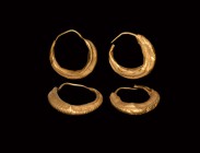 Egyptian Gold Earring Pair
Late Period, 664-332 BC. A matched pair of gold earrings, each a hollow-formed crescent with segmented detailing to the ou...