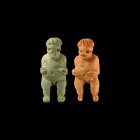 Egyptian Figural Amulet Group
Roman Period, 30 BC-323 AD. A pair of glazed composition amuletic figurines, each a nude male with hands on the hips, p...