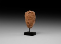 Greek Terracotta Medusa Head
4th-1st century BC. A terracotta plaque with head of Medusa in half-round with fleshy features, wings to the brow, curly...