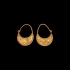 Thracian Gold Earring Pair
3rd century BC. A pair of gold earrings formed as crescent plaque with double filigree border and granulation, two opposin...