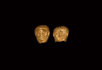 Greek Gold Head Finial Pair
5th-3rd century BC. A pair of sheet gold finials each formed as a janiform head with lentoid eyes, triangular nose, small...