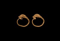 Greek Gold Bull's Head Earring Pair
5th century BC. A matching pair of gold earrings with expanding shank of twisted gold wire, separately applied bu...