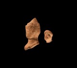 Greek Terracotta Head Group
1st century BC-1st century AD. A pair of terracotta heads comprising: a small female head with applied headdress; a head ...