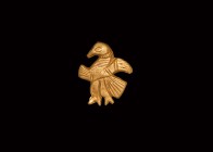 Scythian Gold Bird Appliqué
6th century BC. A sheet gold mount with repoussé design of bird in profile with spread wings and segmented tail, hatching...