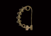 Greek Bow Brooch
5th-3rd century BC. A substantial bronze brooch comprising a round-section bow with four evenly spaced lobes, coil spring and pin to...