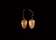 Greek Gold Leaf Earring Pair
5th-3rd century BC. A matching pair of gold earring components formed as a single leaf with raised central vein, one wit...
