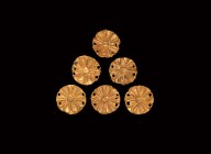 Greek Gold Appliqué Group
5th-3rd century BC. A group of six gold rosette appliqués, all pierced through the rim for attachement. 0.66 grams total, 1...