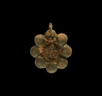Parthian Face Pendant
1st-2nd century AD. A bronze pendant with band of eight bosses surrounding a facing gorgoneion amuletic mask. 95 grams, 76mm (3...