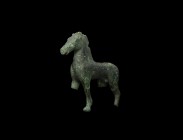 Greek Horse Statuette
5th-3rd century BC. A bronze statuette of a stallion standing with right legs slightly forward in motion, head held forward wit...