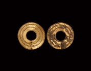Italic Gold Earring Pair
7th-5th century BC. A matched pair of gold earring hoops, each formed as an annular panel with applied concentric filigree. ...
