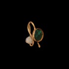 Roman Gold Earring
2nd-3rd century AD. A gold earring with S-shaped hook, discoid cell with green glass insert to the front, the loop with iridescent...