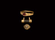 Roman Gold Artefact Group
1st-4th century AD. A mixed group of gold items comprising: a ring with flat-section hoop, angled shoulders, inset carnelia...