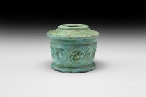Roman Blue Glass Pyxis
1st century AD. An opaque blue mould-blown glass pyxis formed as a cylindrical body with alternating rosettes and bosses, roun...